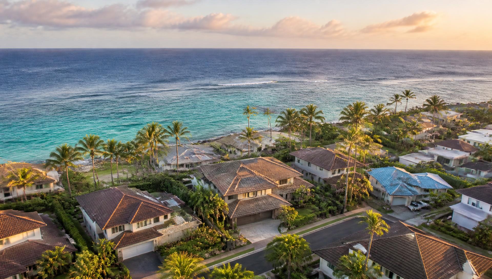 Aerial view of an Oahu coastal residential neighborhood at golden hour